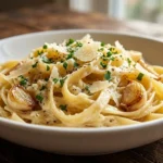 Creamy Garlic Parmesan Pasta served in a white bowl with parsley and parmesan cheese